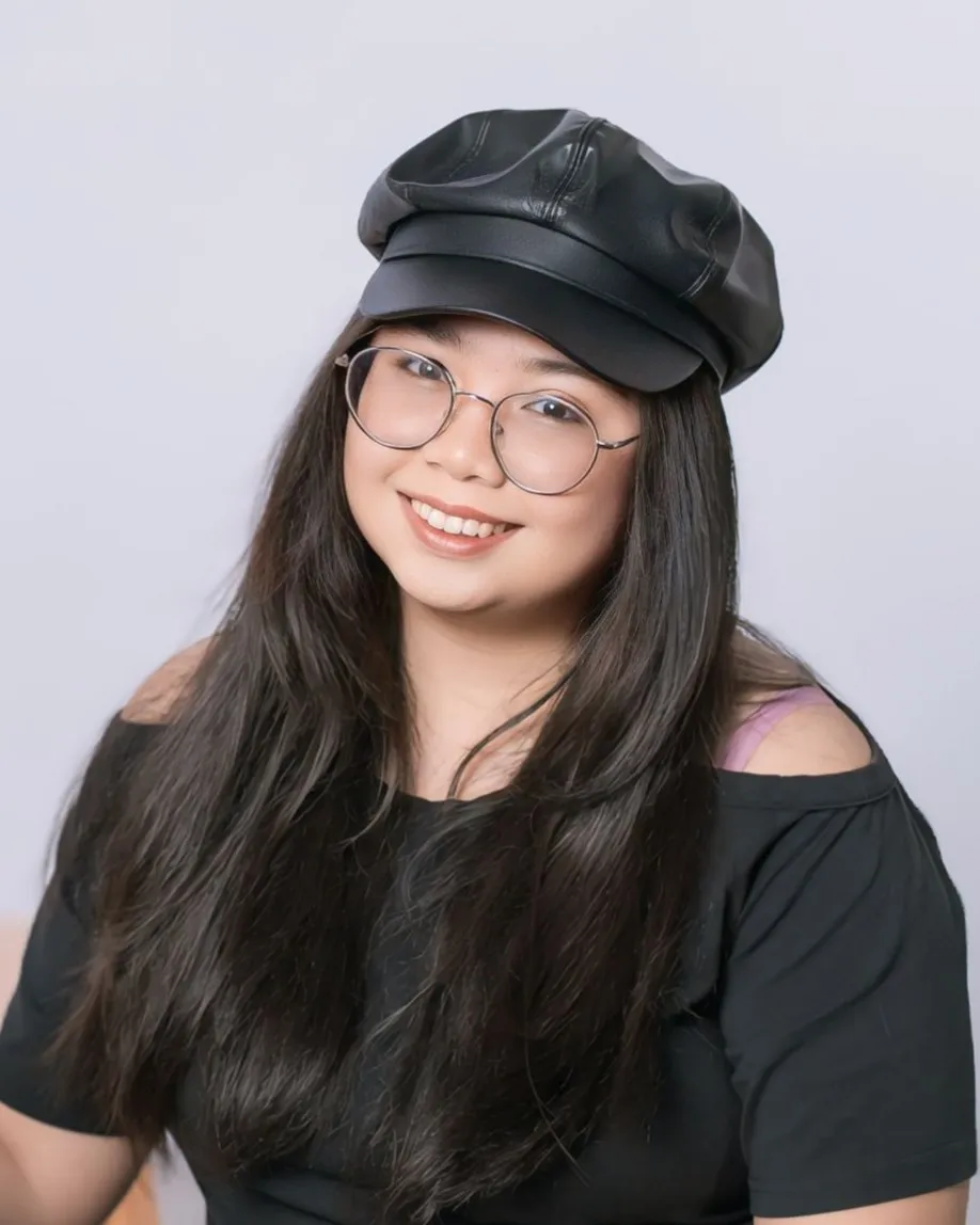Angel Gucio, LaunchKin strategy and design lead, smiling in glasses and a black cap